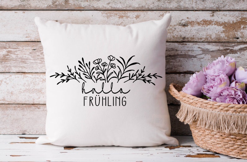 May include: White pillow with black floral design and the text "hallo fr&uuml;hling" printed on it.