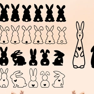May include: A set of 18 black and white bunny silhouettes with hearts. The bunnies are in various sizes and poses, some standing, some sitting, and some hopping.