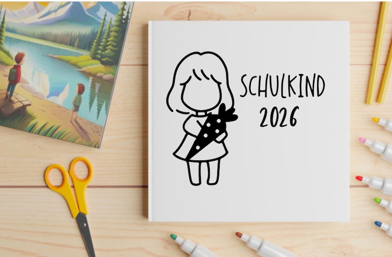 May include: A white notebook with a black illustration of a child holding a carrot, with the text "SCHULKIND 2026". The image also includes a colorful landscape painting, yellow scissors, and markers.