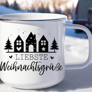 May include: White enamel mug with a black and white design of houses, trees, and stars. The text "Liebste Weihnachtsgr&uuml;&szlig;e" is printed on the mug.