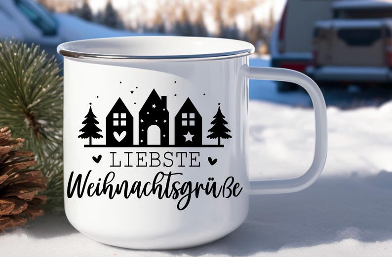 May include: White enamel mug with a black and white design of houses, trees, and stars. The text "Liebste Weihnachtsgr&uuml;&szlig;e" is printed on the mug.