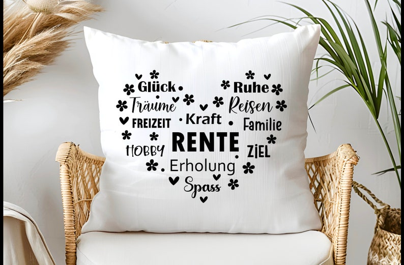 May include: White throw pillow with black text that reads "* Gl&uuml;ck. * Ruhe * * Tr&auml;ume * Reisen * FREIZEIT. Kraft. Familie * * HOBBY RENTE ZIEL * . Erholung * Spass *"
