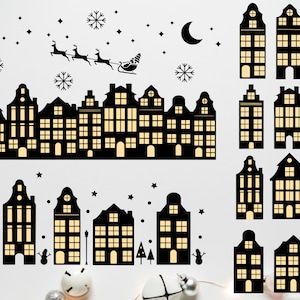 May include: Black and white silhouette illustration of a winter cityscape with snow, stars, and a crescent moon. The cityscape features a row of houses with windows and a sleigh pulled by reindeer.