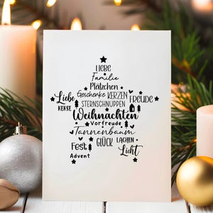May include: A white card with a black Christmas tree design. The tree is made up of words like "love", "family", "gifts", "candles", "joy", and "Christmas".