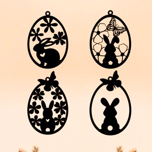 May include: Four black silhouette Easter egg ornaments with a bunny rabbit and floral designs. Each egg has a small loop at the top for hanging.