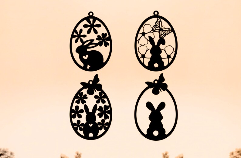 May include: Four black silhouette Easter egg ornaments with a bunny rabbit and floral designs. Each egg has a small loop at the top for hanging.