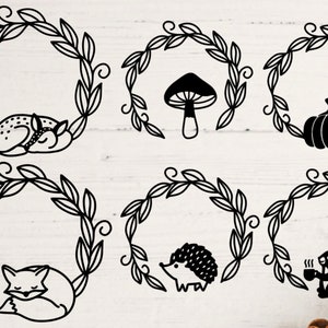 May include: Six black and white illustrations of wreaths with various woodland creatures inside. The wreaths are made of leaves and have a simple, hand-drawn style. The creatures include a deer, a mushroom, a pumpkin, a fox, a hedgehog, and a squirrel.