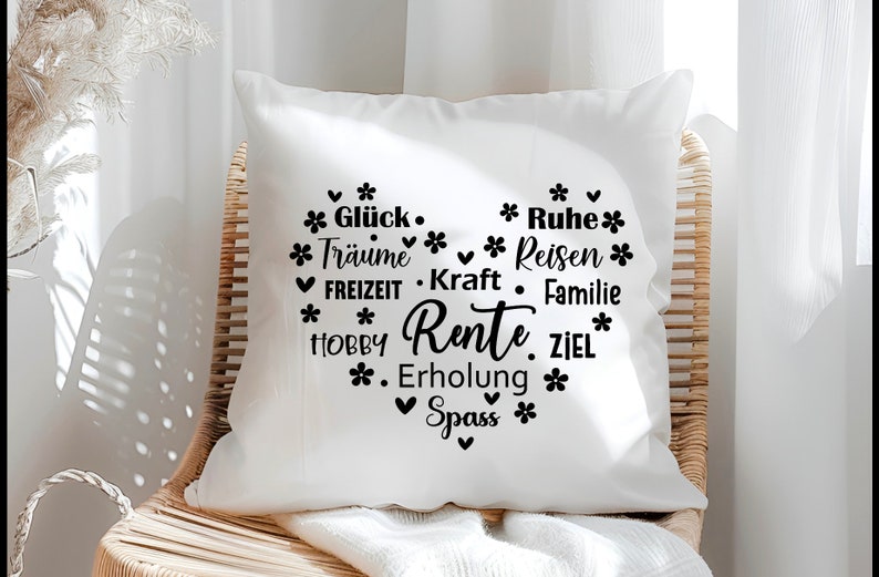 May include: White throw pillow with black text that reads "Gl&uuml;ck. Tr&auml;ume. Reisen. FREIZEIT. Kraft. Familie. HOBBY. Rente. ZIEL. Erholung. Spass." The text is arranged in a heart shape.