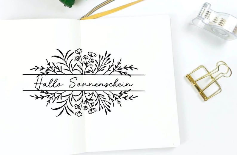 May include: A black and white illustration of a floral wreath with the text "Hallo Sonnenschein" in the center.