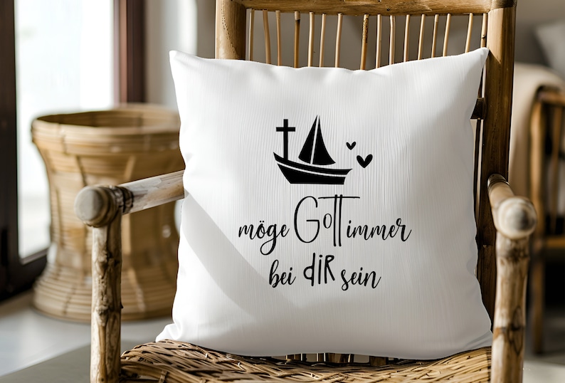 May include: White throw pillow with black text that reads "m&ouml;ge Gott immer bei dir sein" and a black silhouette of a sailboat with a cross on the mast and two hearts.