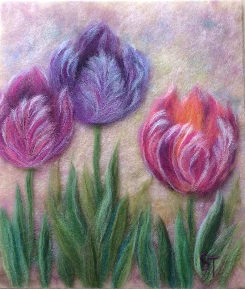 May include: Three purple and pink tulips with green leaves on a light pink background. The tulips are made of wool felt and have a soft, fuzzy texture.