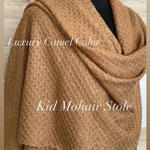 May include: A camel-colored Kid Mohair stole. The soft, textured fabric is draped over a black form. The text "Luxury Camel Color" and "Kid Mohair Stole" are displayed on the image.