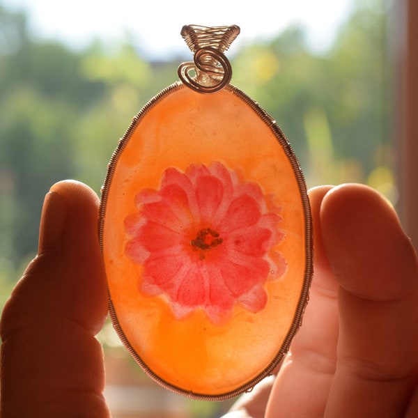 An orange pendant with a red flower inside (synthetic resin)!