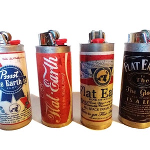 May include: Four silver lighters with different designs. The lighters are decorated with images and text related to the flat earth theory. The text on the lighters includes "Possst The Earth is Flat", "Enjoy Flat Earth It's the REAL thing!", "Flat Earth King of Reality", and "Flat Earth Is The Truth The Globe Is A Lie".