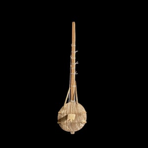 May include: A wooden musical instrument with a round body and a long neck. The instrument is made of natural wood and has a simple design.
