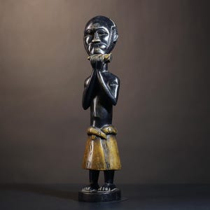 African tribal male figure holding flute carved wood musician statue cultural decor ancestral carving music heritage art piece-G4903