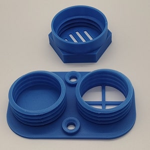 May include: Two blue 3D printed containers with lids. One container has two compartments, each with a lid. The other container has a single compartment with a lid. The lids have a grid pattern.