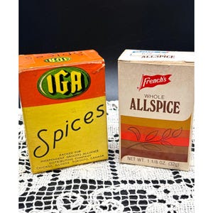 May include: Two vintage spice boxes. One is orange and yellow with "IGA Spices" in large script. The other is tan with "French's Whole Allspice" and a graphic of leaves. The Allspice box is labeled "NET WT. 1 1/8 OZ. (32g)".
