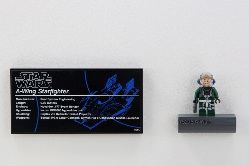 May include: A black and blue Star Wars A-Wing Starfighter model with a white background. The model is 9.60 meters long and has a Kuat System Engineering manufacturer. The model has a Novaldex J-77 Event Horizon hyperdrive unit, an Incom GBK-785 hyperdrive unit, a Sirplex 2-9 Deflector Shield Projector, and Borstel RG-9 Laser Cannons, Dymek HM-6 Concussion Missile Launcher.