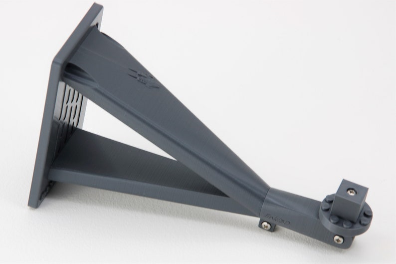 May include: A gray plastic wall mount with a rectangular base and a long, angled arm. The arm has a square connector at the end with a screw.