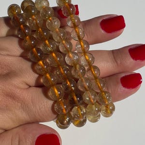 One (1) Golden Rutilated Quartz Crystal Bracelet (intuitively chosen)