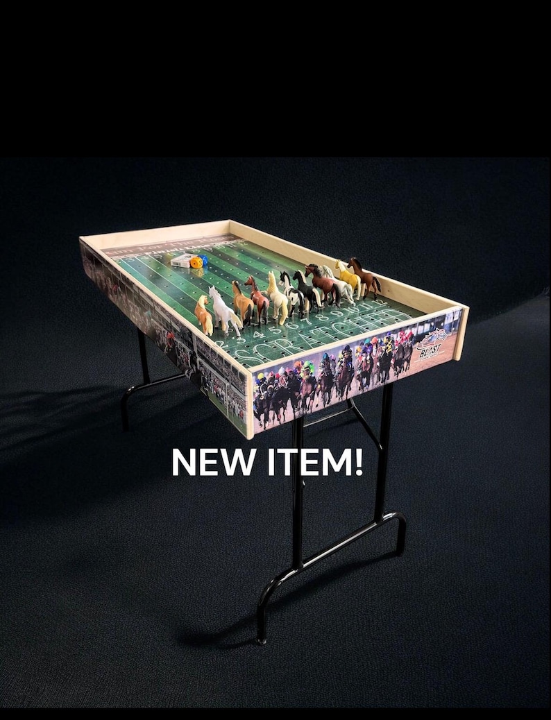 May include: A wooden tabletop horse racing game with a green felt playing surface and colorful plastic horses. The game is set up on a black metal folding table. The text "NEW ITEM!" is printed below the table.