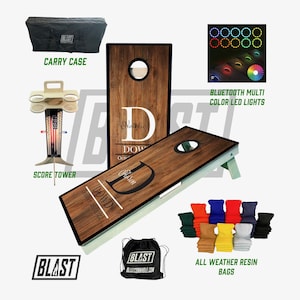 May include: A personalized cornhole set with a wooden board, a score tower, a carry case, and a set of bean bags. The board has a custom design with the names "Natalie" and "Jason" and the date "October 29, 2022". The set also includes multi-color LED lights that can be controlled via Bluetooth.