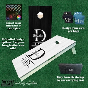 May include: A white and black personalized cornhole set with the names Bradley and Mallory Davis and the date 08.23.2025. The set includes a carrying case and two sets of bean bags.