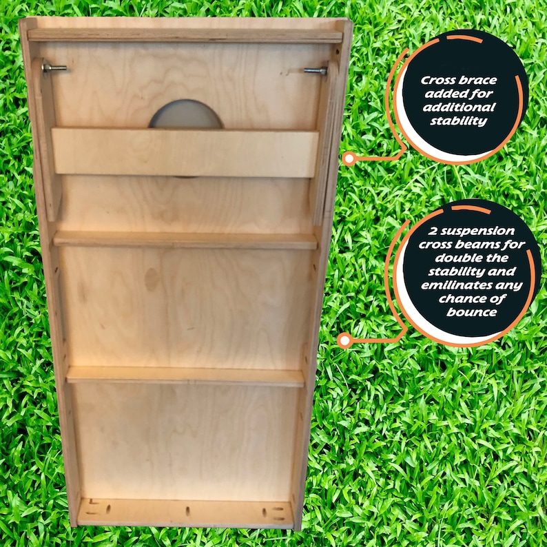 May include: A wooden cornhole game board with a back panel that has three shelves and a cross brace for stability. The text "Cross brace added for additional stability" and "2 suspension cross beams for double the stability and eliminates any chance of bounce" is written on the image.