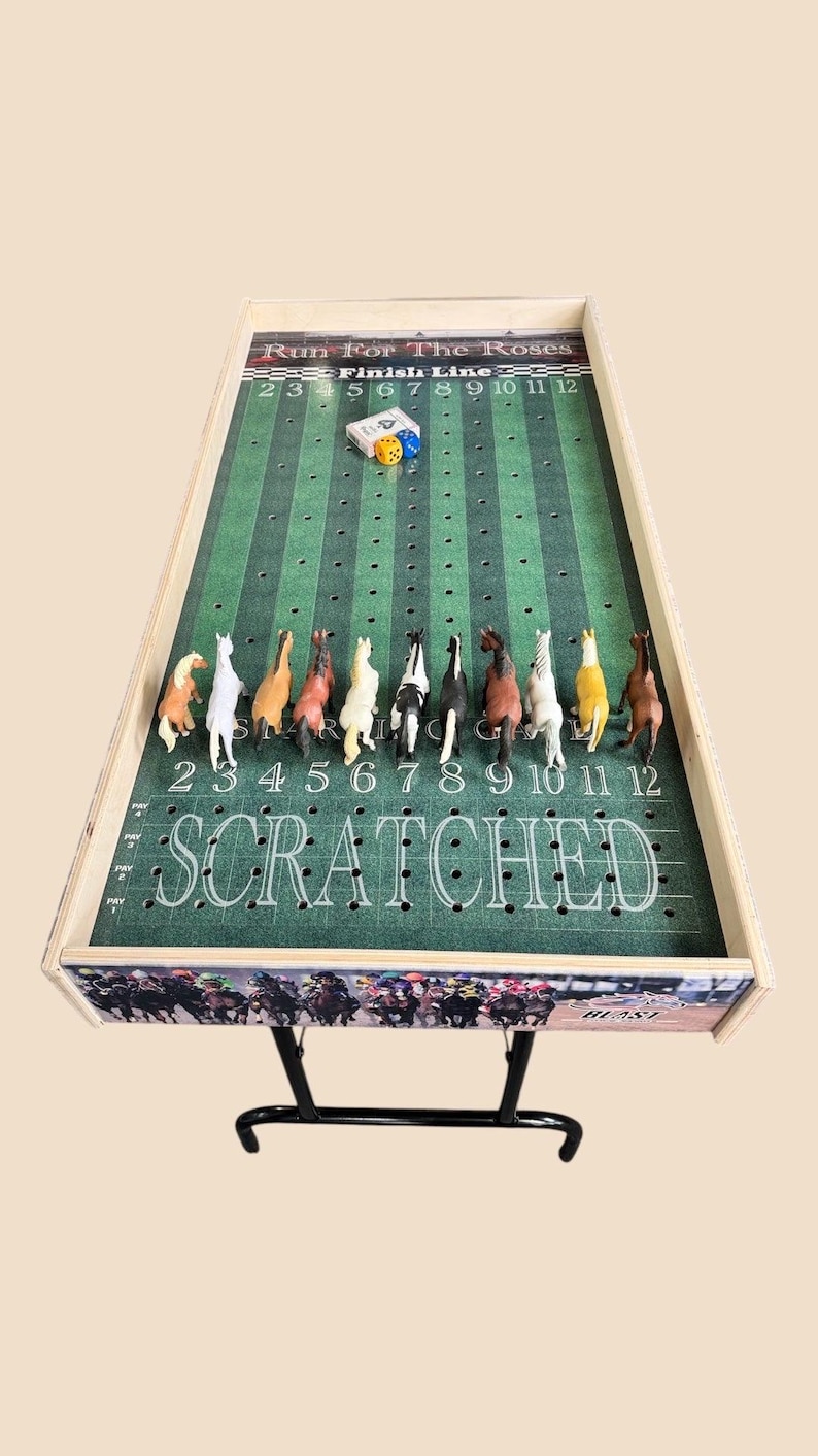 May include: A wooden game board with a green felt playing surface and a horse racing theme. The board has a finish line, numbered spaces, and a 'SCRATCHED' area. There are 12 plastic horses on the board, and two dice are in the center of the board.