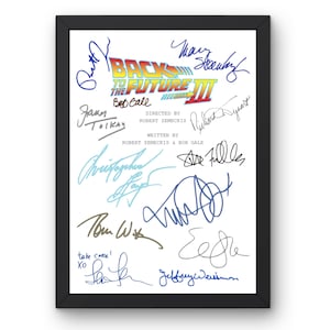 May include: Framed print featuring the "Back to the Future III" movie title and signatures. The print has a white background with the movie title in yellow, red, and blue. The signatures are in various colors, and the frame is black.