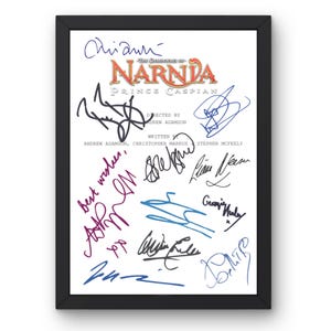 May include: Framed print of "The Chronicles of Narnia: Prince Caspian" with multiple signatures. The title is in orange and gold, with the names of the director and writers below. The signatures are in various colors, including blue, purple, and black.