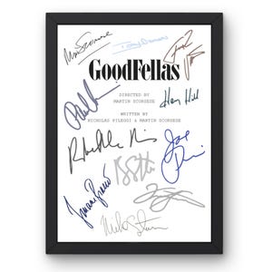 May include: Framed print featuring the movie title "GoodFellas" with multiple signatures in various colors. The text includes "Directed by Martin Scorsese" and "Written by Nicholas Pileggi & Martin Scorsese". The print is in a black frame.