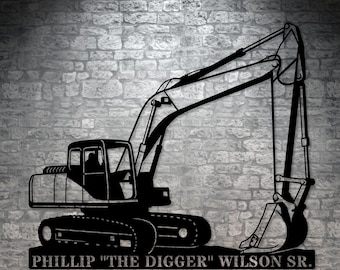 May include: Black metal silhouette of an excavator with the text "Phillip "The Digger" Wilson Sr." below.