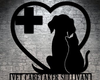 May include: Black metal silhouette of a dog and cat inside a heart shape with a cross and the text "VET CARETAKER SULLIVAN" below.