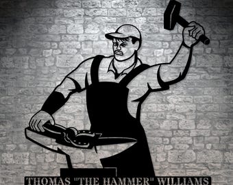 May include: Black metal silhouette of a blacksmith holding a hammer and working on an anvil. The silhouette is on a brick wall background. The text "THOMAS "THE HAMMER" WILLIAMS" is below the silhouette.