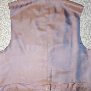 May include: A white ceramic mug with a black handle and the text "But First, Coffee" in a handwritten style. The mug is on a white surface. The mug is approximately 10 cm tall.