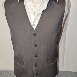 May include: A white ceramic mug with a black handle and the text "But First, Coffee" in a black, bold font. The mug is on a white surface.