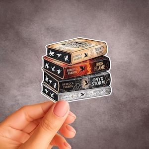 May include: A sticker featuring a stack of four books by Rebecca Yarros. The titles are Fourth Wing, Iron Flame, Onyx Storm, and Threshing Day. Each book spine displays dragon silhouettes, clouds, and fire imagery in tan, red, black, and grey tones.