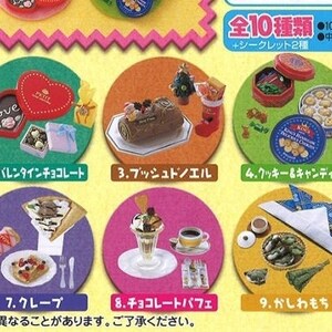 May include: A collection of miniature food items, including cookies, cakes, and drinks, arranged in colorful circles. The image features various desserts and snacks, such as a chocolate log, ice cream, and a Valentine's Day chocolate box. Japanese text is present.