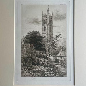 May include: Framed black and white print of a church. The detailed etching shows a church with a tall tower, surrounded by trees, a stone wall, and a cottage. The artwork is signed in the lower left corner.