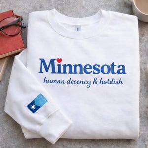 May include: A rustic wooden sign with the text "Welcome to our home" in white lettering. The sign features a distressed finish and a simple, inviting design, perfect for front door decor.