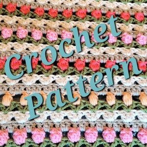 Puede incluir: Patrón de ganchillo con un diseño a rayas en hilo rosa, verde, blanco y beige. El patrón incluye una fila de pequeños puntos en forma de flor.