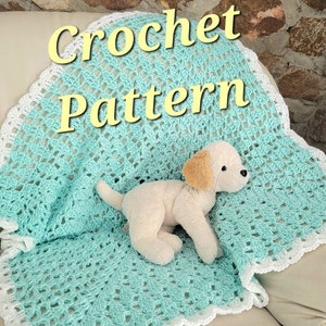 May include: A light blue crochet baby blanket with a white crocheted border. The blanket is on a white couch with a small stuffed dog on top of it. The text "Crochet Pattern" is written in yellow letters on the blanket.