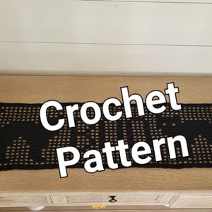 May include: Black crochet table runner with a geometric pattern. The runner is on a wooden surface and the text "Crochet Pattern" is superimposed on the image.