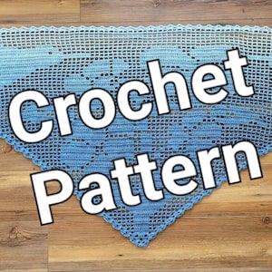 May include: A blue crochet shawl with a gradient of color from light blue to dark blue. The shawl is laid out on a wooden surface with the text "Crochet Pattern" superimposed on the image.