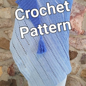 May include: A light blue crochet shawl with a white tassel. The shawl is displayed on a wooden mannequin against a stone wall. The text "Crochet Pattern" is superimposed on the image.