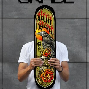 May include: A skateboard deck with a black and yellow design featuring a raven perched on a skull with roses. The text "Until Death" is written in a gothic font.