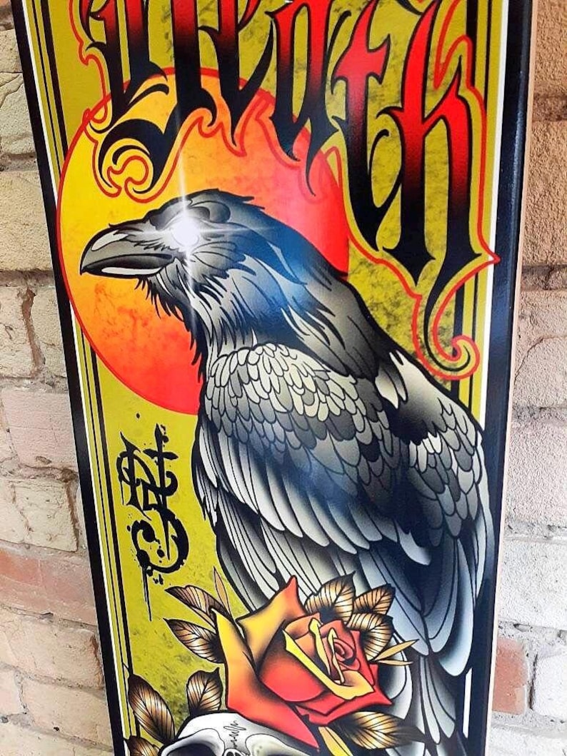 May include: A black raven with a glowing eye, perched on a red rose with a skull at its base. The background is yellow with a red sun and the word "Death" in black lettering.
