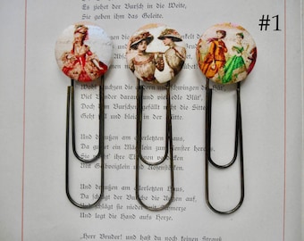 Fashion bookmarks in historical dress; set of 3. Each paperclip bookmark measures 3 3/4".
